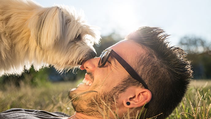 Young man playing with his dog outside