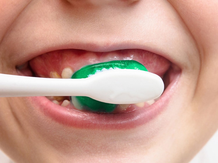 Cropped Image Of Girl Brushing Teeth
