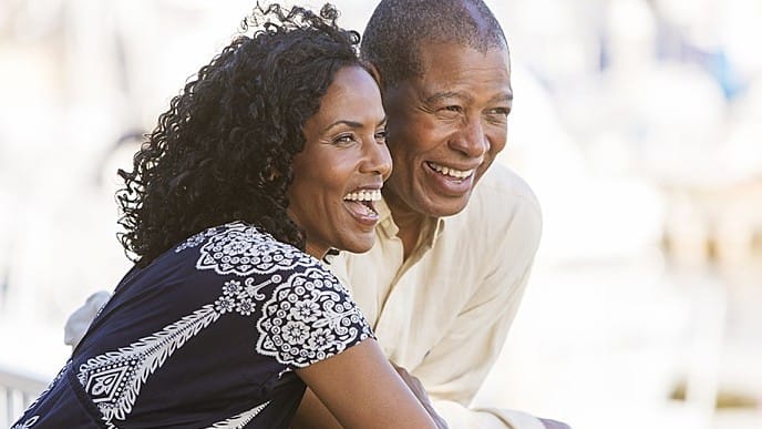 A smiling couple with dental crowns