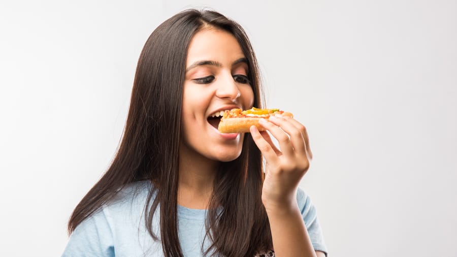 https://www.colgate.com/content/dam/cp-sites/oral-care/oral-care-center/global/article/gscp/asia/beautiful-indianasian-young-girl-eating-slice.jpg